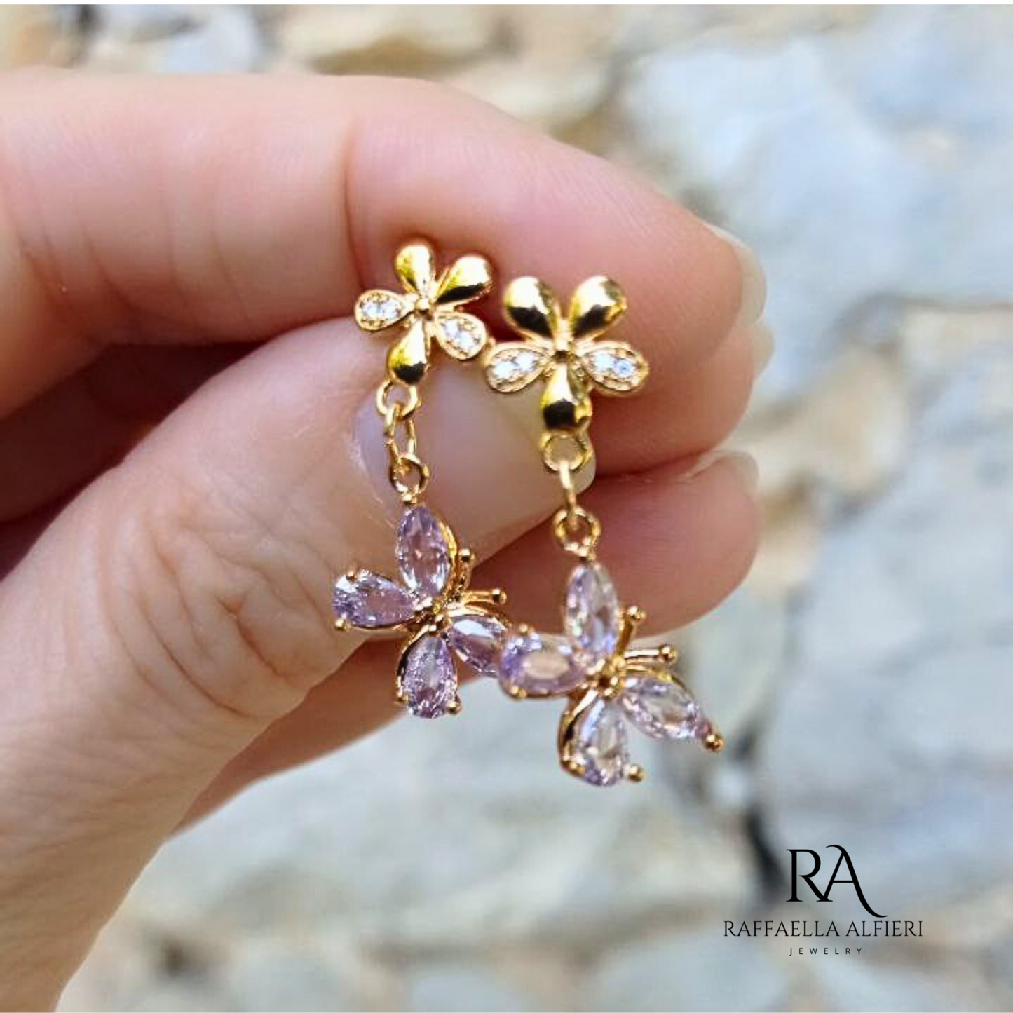 Piccoli orecchini pendenti a forma di farfalla con zirconi viola e perno a fiore